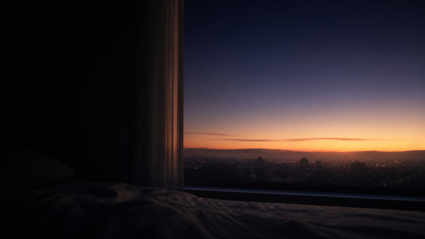 First light appearing over a quiet city before dawn